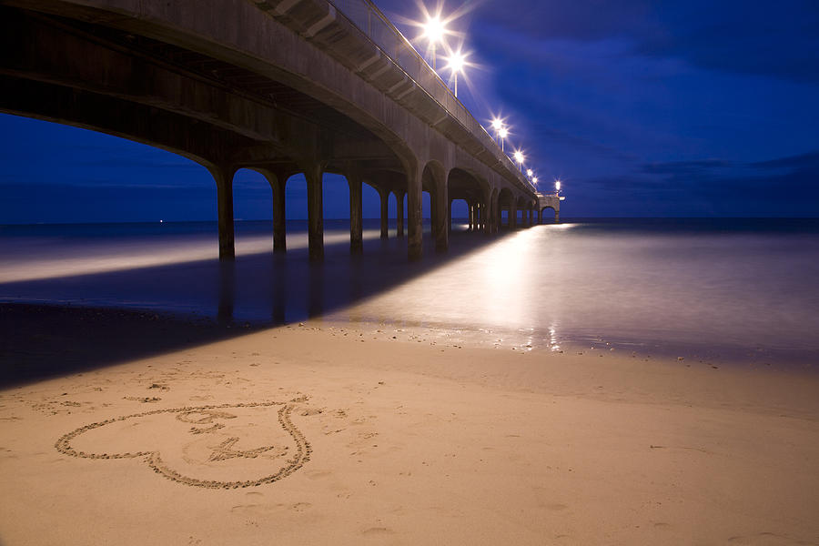 Love heart in the sand at Boscombe Pier Photograph by Ian Middleton