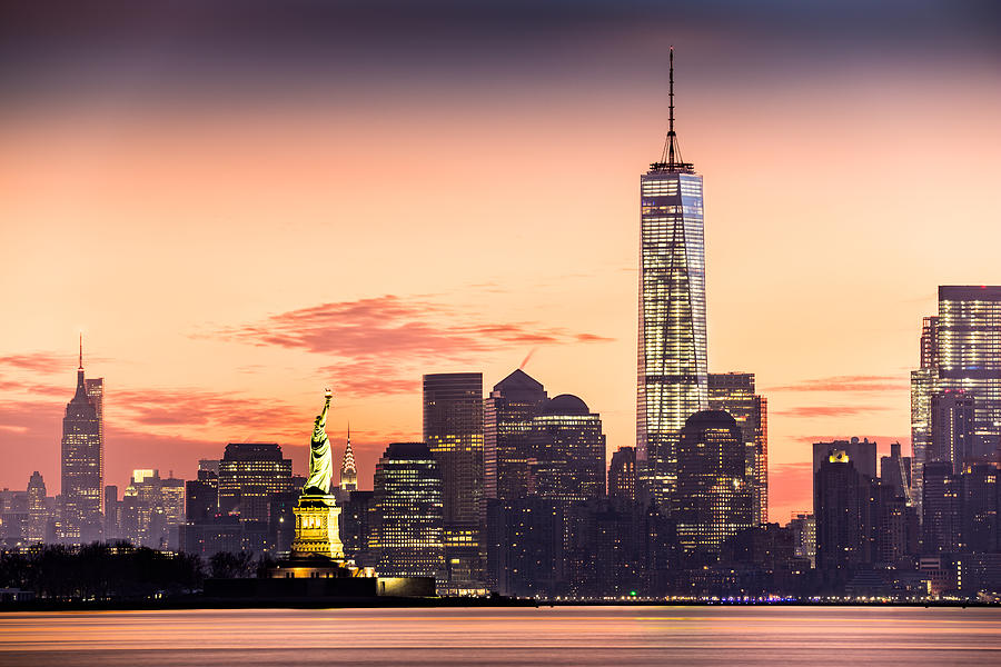 Lower Manhattan and the Statue of Liberty at sunrise #1 Photograph by Mihai Andritoiu