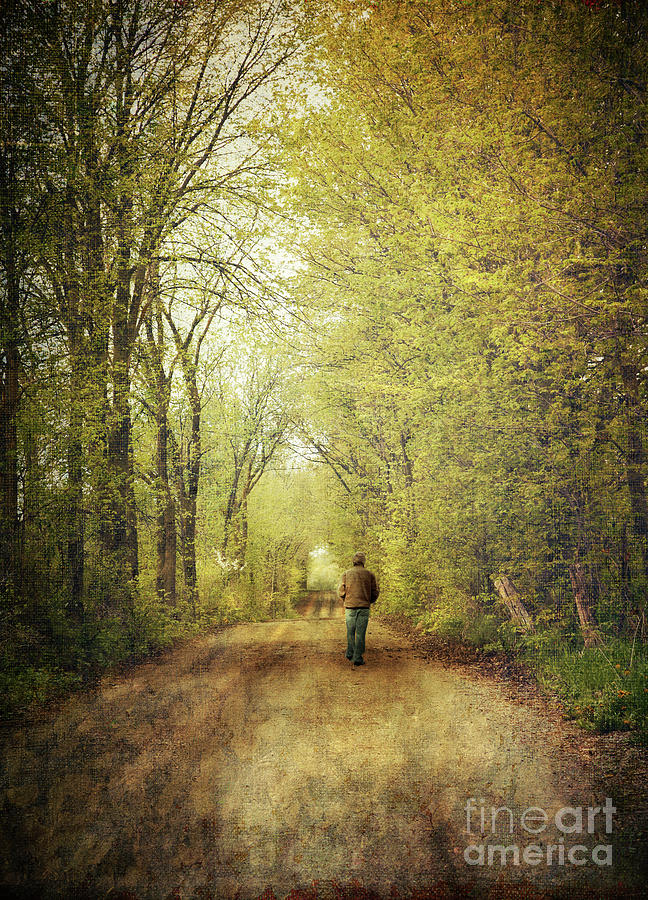 Fall Photograph - Man walking  on a lonely country road #1 by Sandra Cunningham