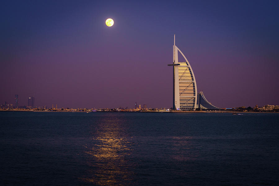 Moonrise over Burj Al Arab Photograph by Alexey Stiop