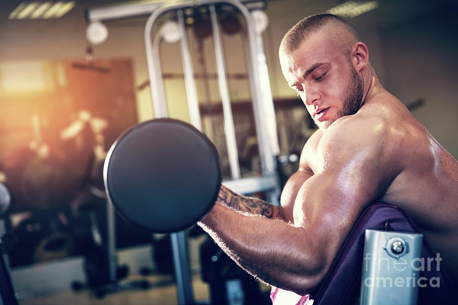 Muscular Man Working Out At A Gym. Photograph