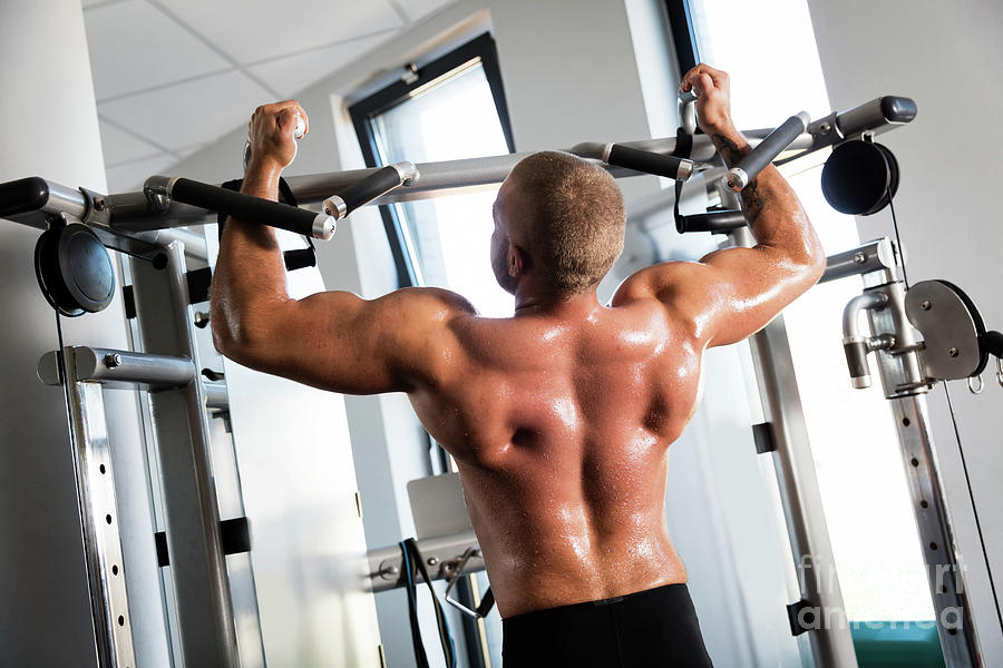 Muscular Strong Man Working Out At A Gym. Photograph