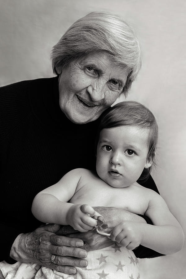 Old Gray-haired Grandmother Sits With A Small Grandson Photograph
