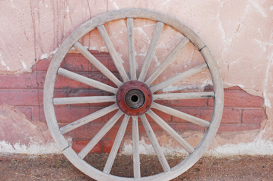Brick Photograph - Old wooden wagon wheel #1 by Ingrid Perlstrom