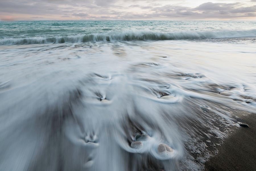 Pebbles in the beach and flowing sea water Photograph by Michalakis Ppalis