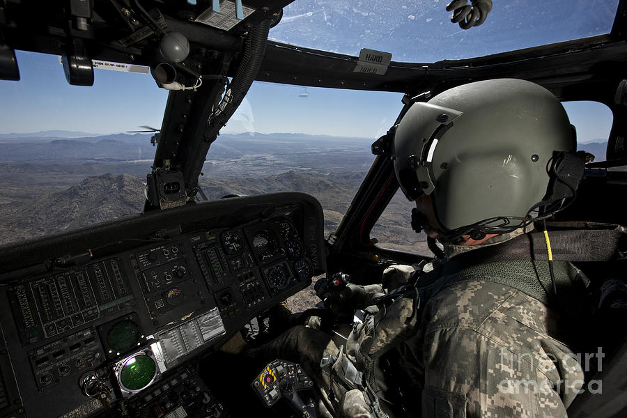 Pilot Operating The Cockpit Of A Uh-60 Photograph