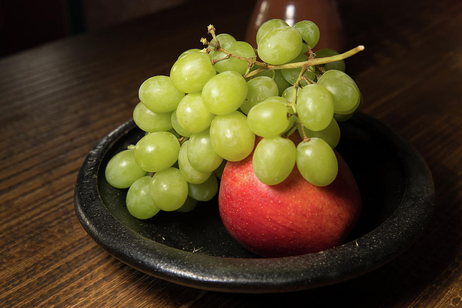 Red Apple And Green Grapes On A Black Plate Photograph