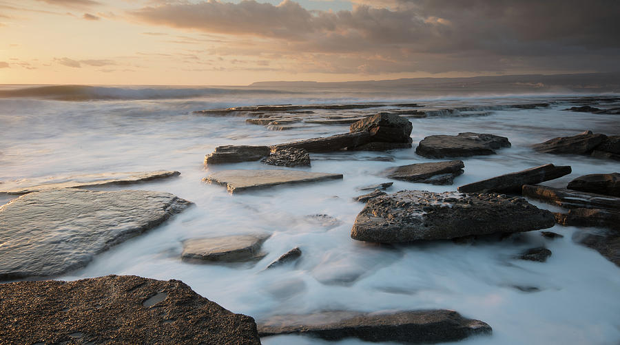 Rocky seashore seascape with wavy ocean during sunset  #1 Photograph by Michalakis Ppalis