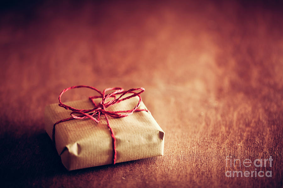 Christmas Photograph - Rustic retro gift, present box with red ribbon. Christmas time #1 by Michal Bednarek
