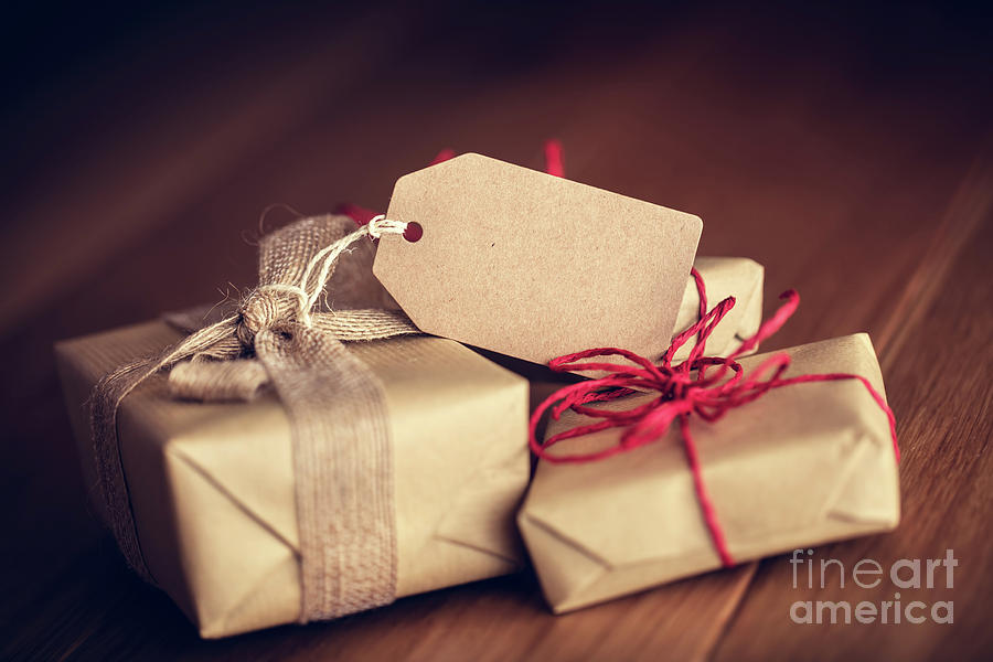 Christmas Photograph - Rustic retro gift, present boxes with tag. Christmas time, eco paper wrap. #1 by Michal Bednarek