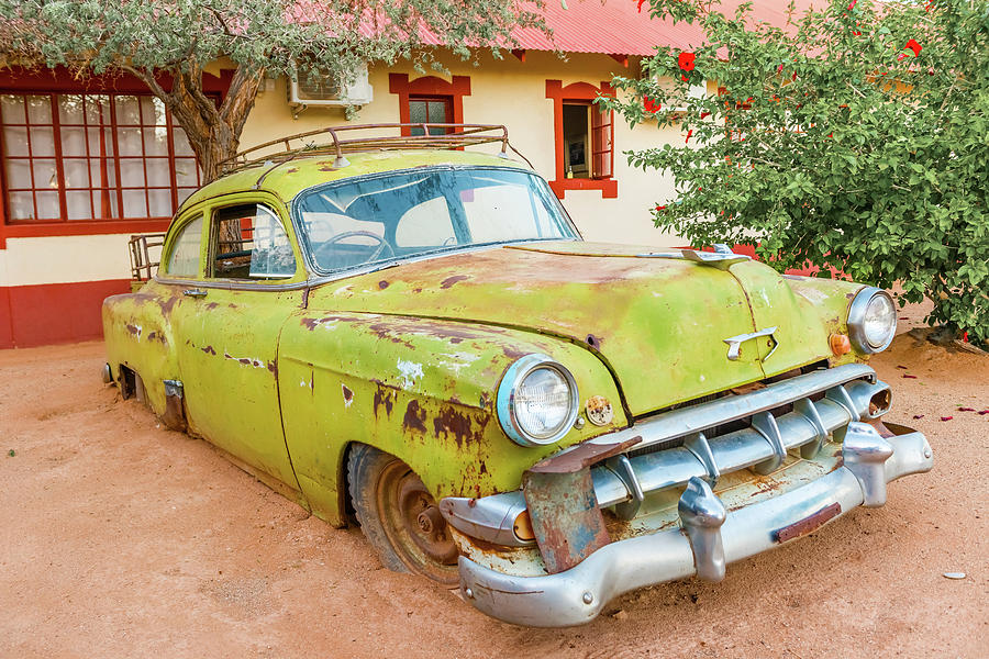 Rusty vintage car in Namibia #1 Photograph by Marek Poplawski