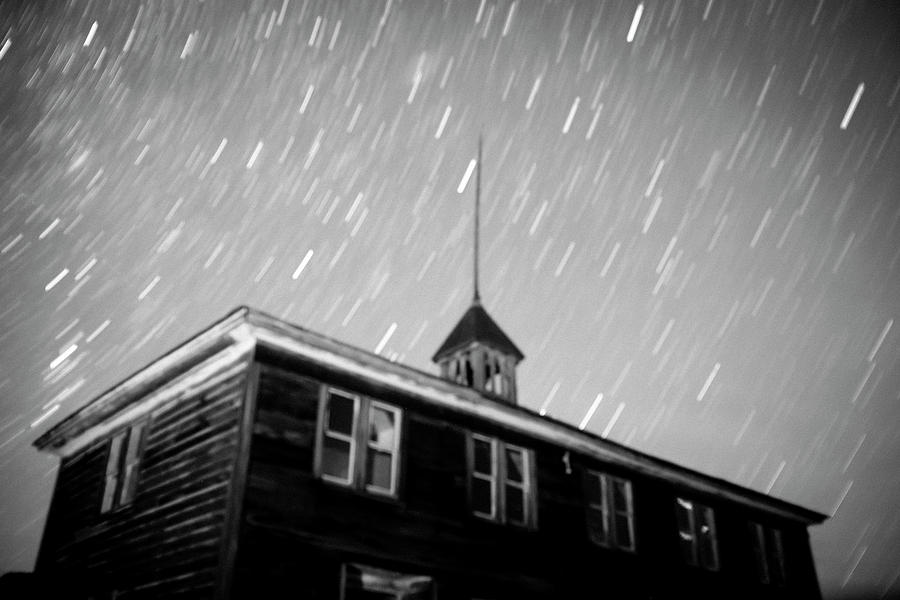 Schoolhouse blurred and illuminated in Bodie, California at nigh #1 Photograph by Karen Foley