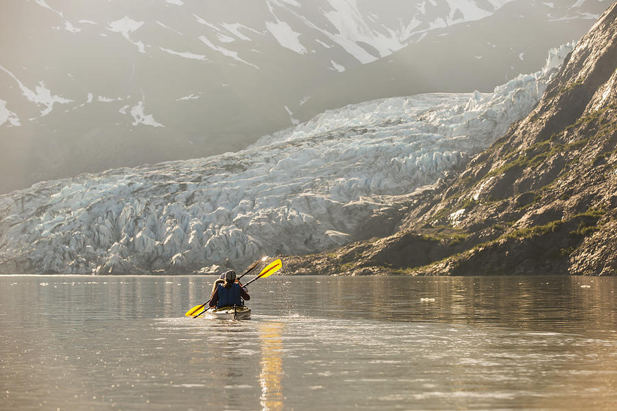 Sea Kayakers Paddling In Evening Light #1 Photograph by Kevin Smith