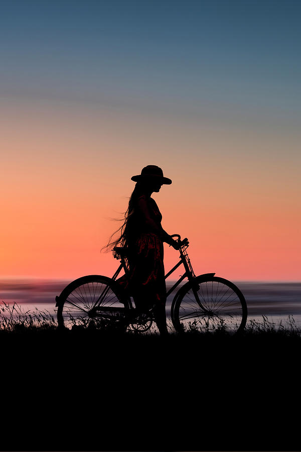 Sunset Photograph - Silhouette Of Girl And Bike At Sunset Near The Sea. by Maggie Mccall