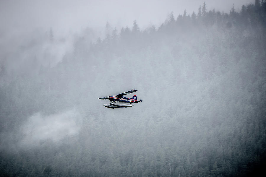 Single Prop Airplane Pontoon Plane flying through fog over Alask #1 Photograph by Alex Grichenko