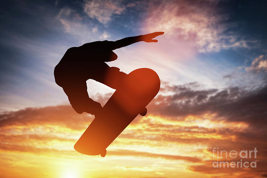 Skateboarder Jumping At Sunset. Photograph