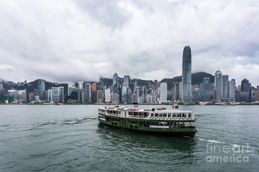 Star Ferry between Kowloon and Hong Kong island on cloudy day #1 Photograph by Didier Marti