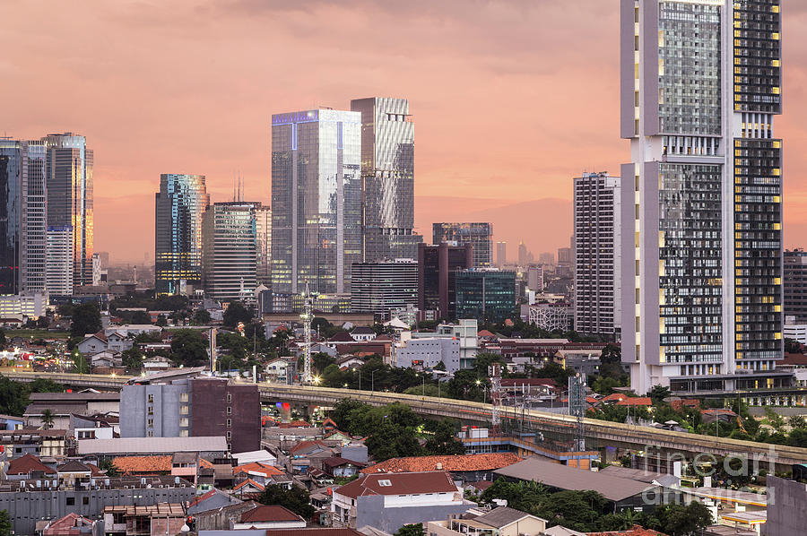 Stunning susnset over Jakarta business district in Indonesia cap #1 Photograph by Didier Marti