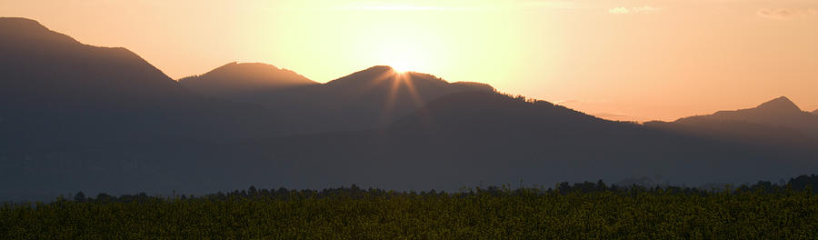 Sunrise bursting over the kamnik alps and rapeseed #1 Photograph by Ian Middleton