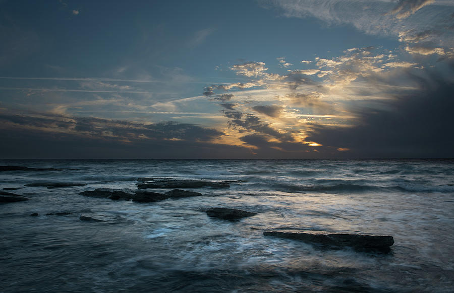 Sunset on a rocky beach  #2 Photograph by Michalakis Ppalis