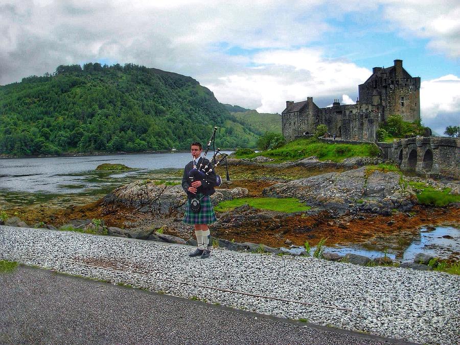 The Piper at Eilean Donan Castle 2 Photograph by Joan-Violet Stretch