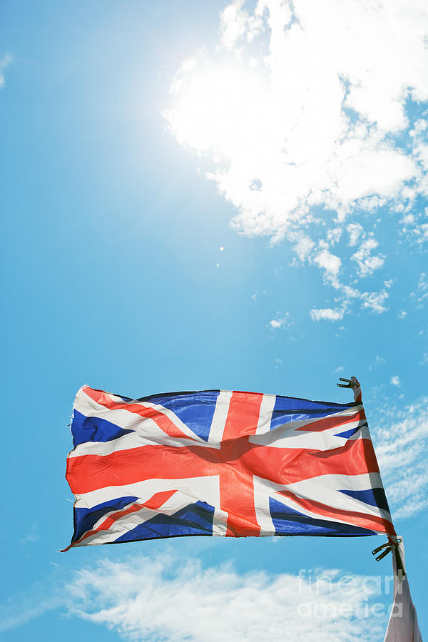 The Union Jack, the national flag of the United Kingdom waving on wind #1 Photograph by Michal Bednarek