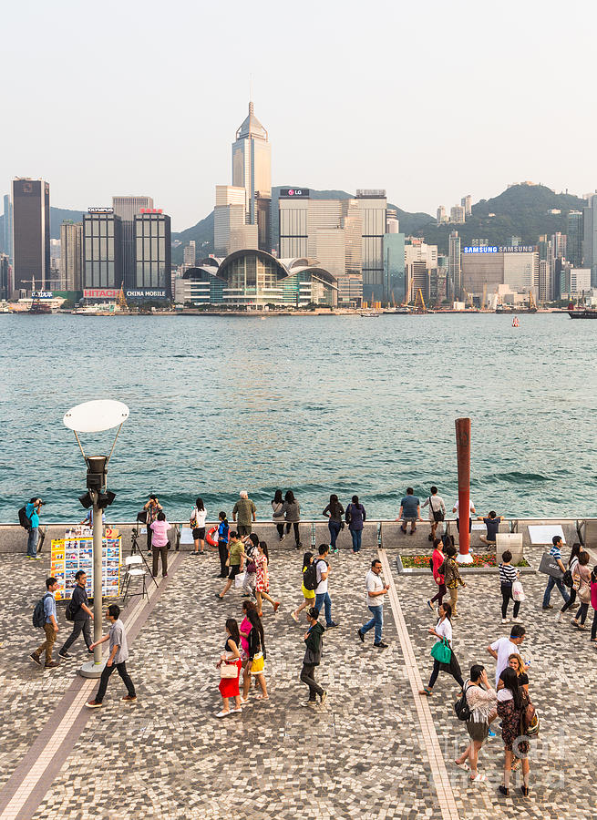 Tourists in Hong Kong waterfront promenade #1 Photograph by Didier Marti