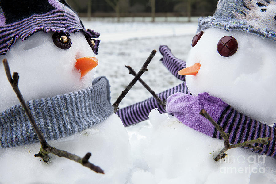 Two cute snowmen friends embracing Photograph by Simon Bratt