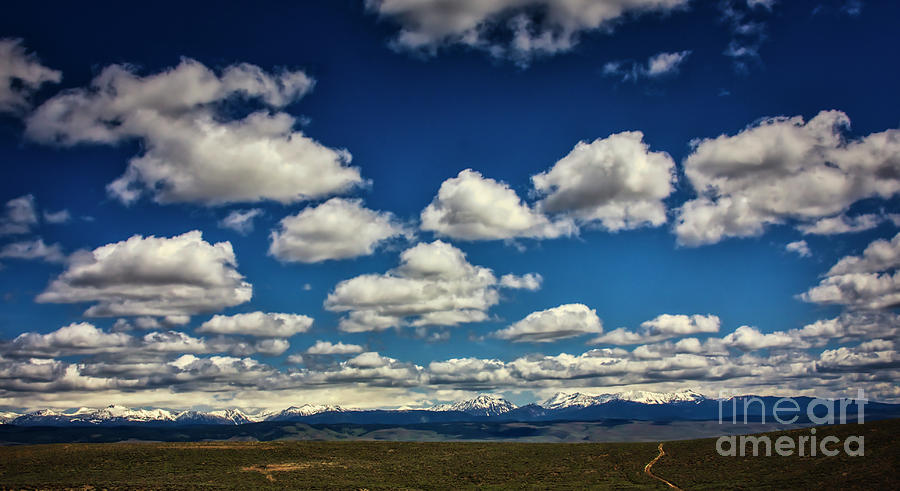 Clouds above the Wallowa Mountain range in Eastern Oregon Photograph by Bruce Block