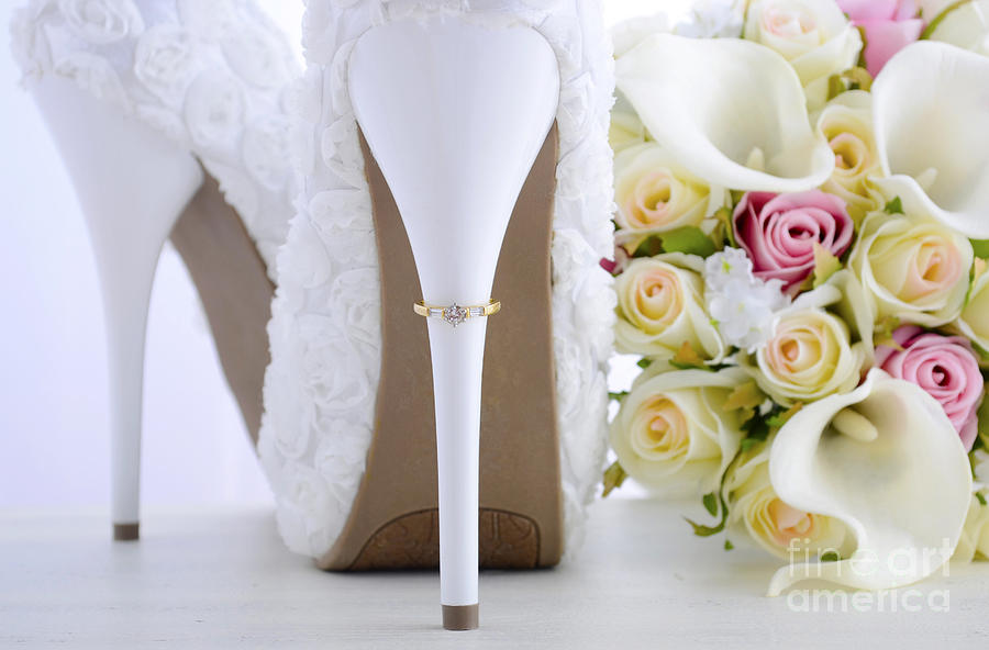 Wedding ring on beautiful white stiletto shoe heel.  #1 Photograph by Milleflore Images
