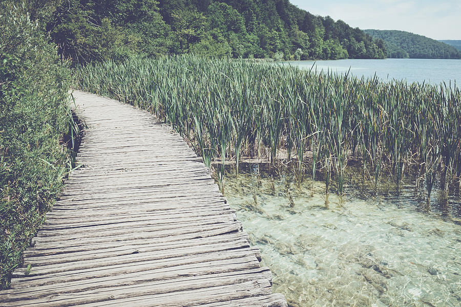 Wooden Bridge over a Lake in Plitvice National Park #1 Photograph by Brandon Bourdages