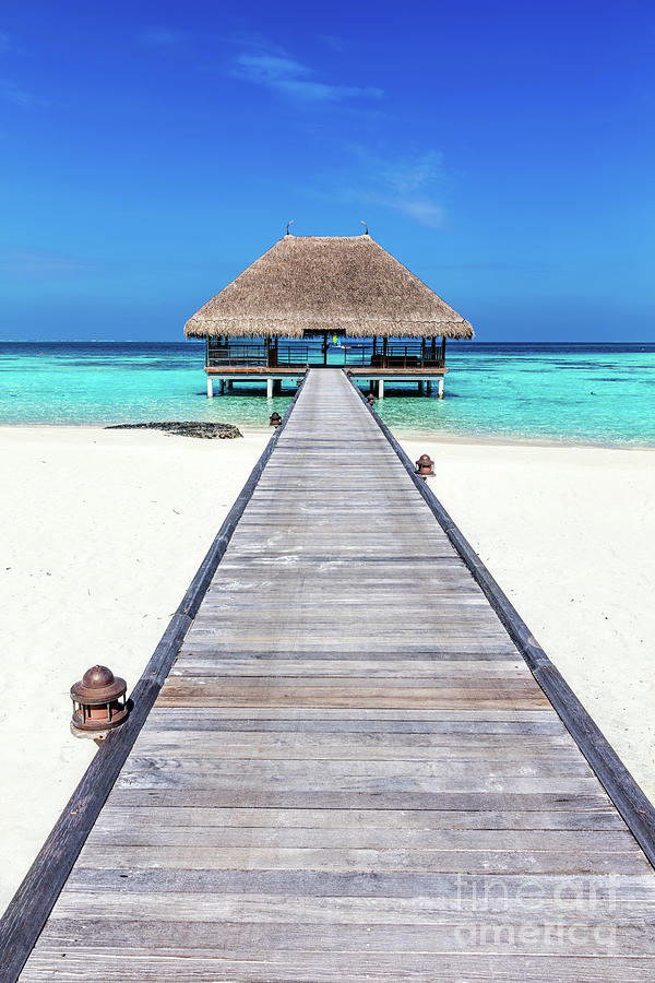 Wooden jetty leading to relaxation lodge. Maldives islands #1 Photograph by Michal Bednarek