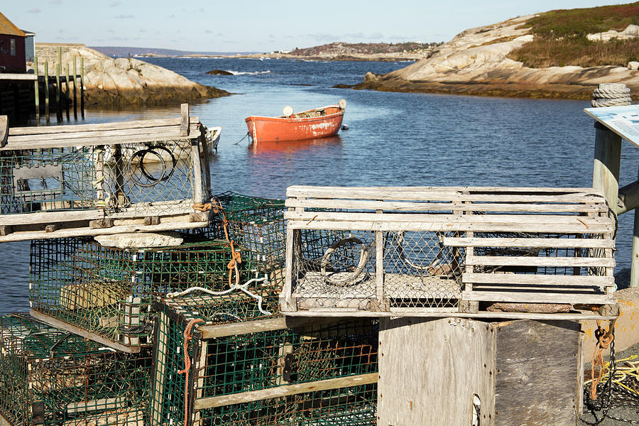 Wooden lobster traps on dock in Peggys Cove, Nova Scotia, Canada #1 Photograph by Karen Foley