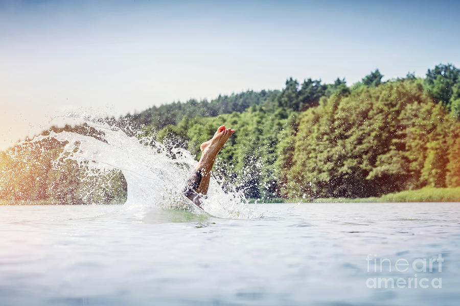 Young man diving into a lake. #1 Photograph by Michal Bednarek
