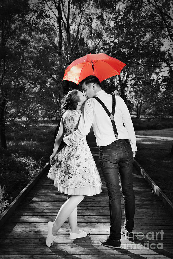 Young romantic couple in love flirting in rain #1 Photograph by Michal Bednarek