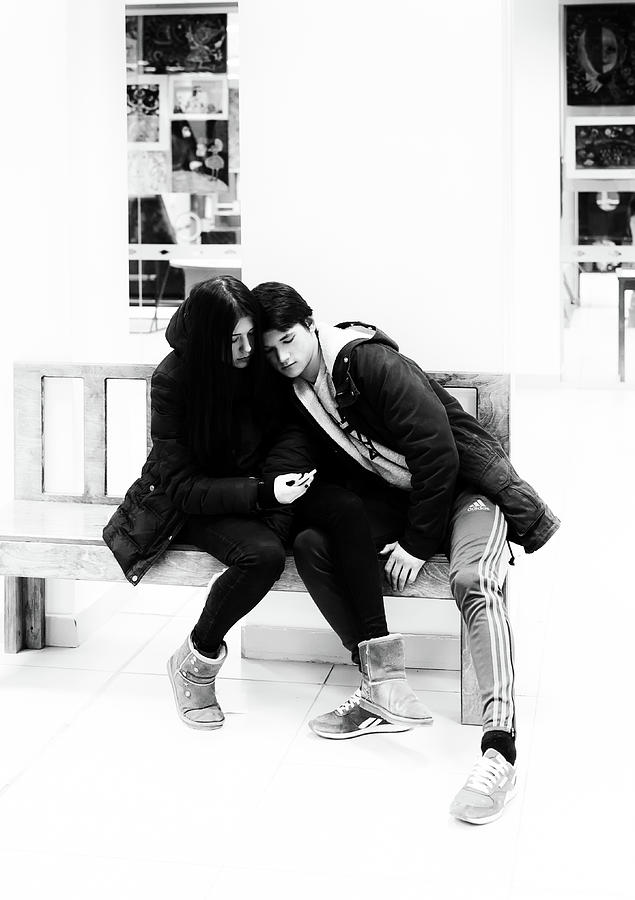 Young Romantic Couple Sharing a Mobile Phone #1 Photograph by John Williams