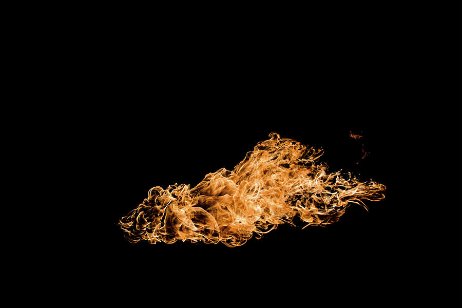 Fire in black background Photograph by Krzysztof Grabiec