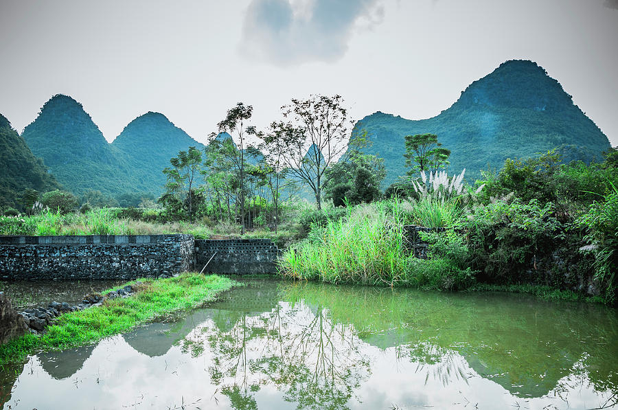 The karst mountains and river scenery #11 Photograph by Carl Ning