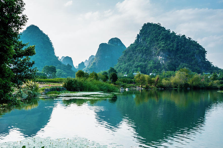 The karst mountains and river scenery #13 Photograph by Carl Ning