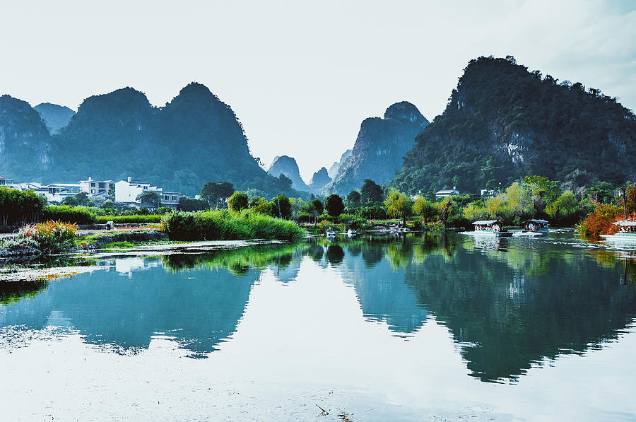 The karst mountains and river scenery #15 Photograph by Carl Ning