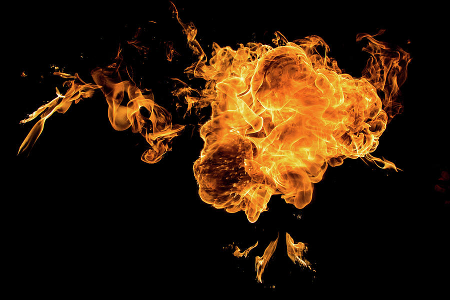 Fire in black background Photograph by Krzysztof Grabiec