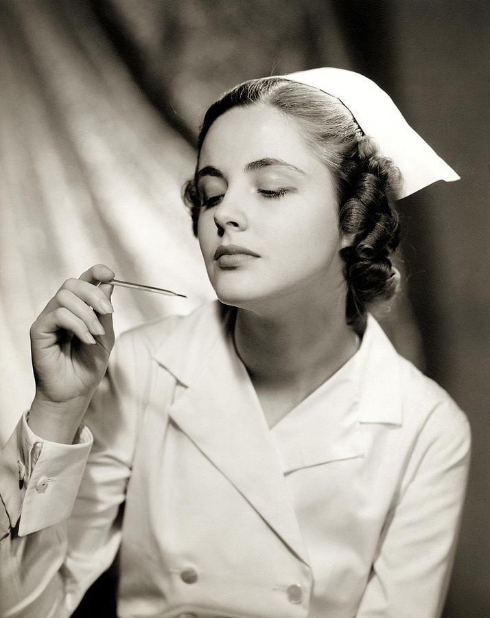 1940 Nurse checking Thermometer Photograph by Historic Image