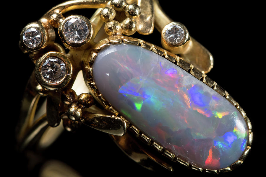 A Golden Ring With A Colorful Opal Gemstone Photograph