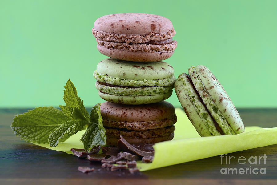 Chocolate and mint flavor macaroons on dark wood table #2 Photograph by Milleflore Images
