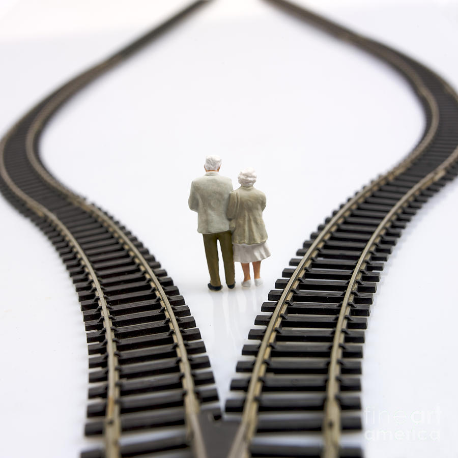 Contemplates Photograph - Figurines between two tracks leading into different directions symbolic image for making decisions. #2 by Bernard Jaubert