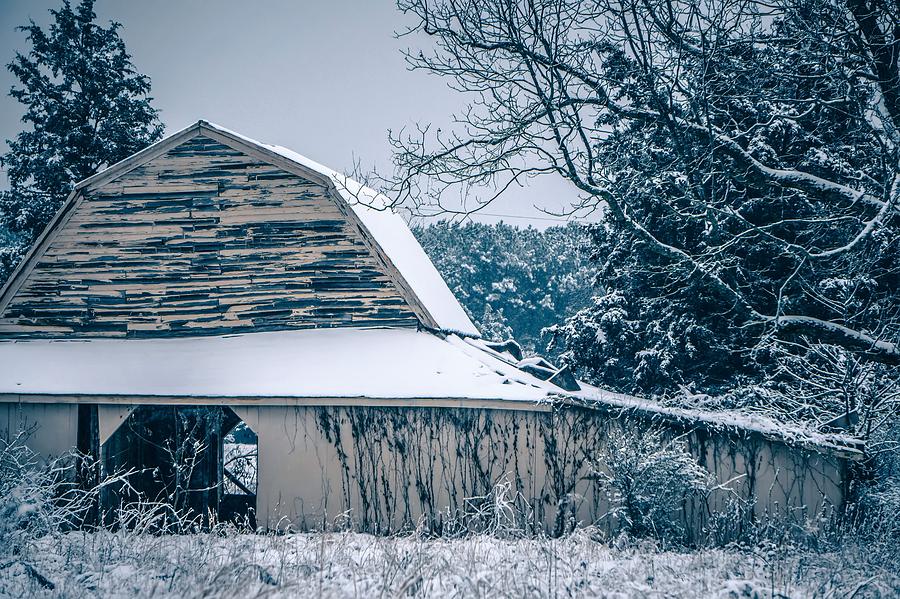 Fresh snow sits on the ground around an old barn #2 Photograph by Alex Grichenko