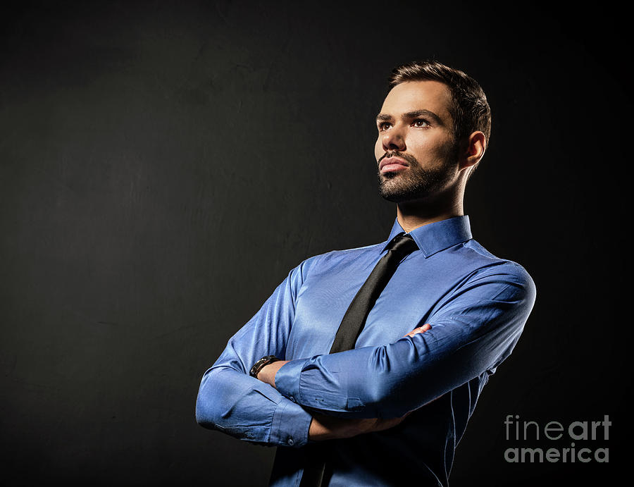 Handsome young businessman standing confident on black #2 Photograph by Michal Bednarek
