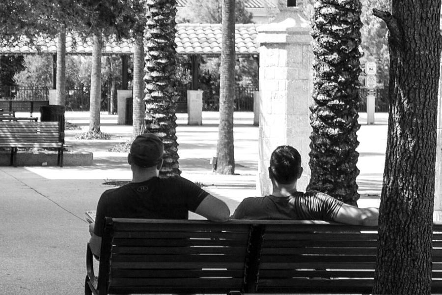 2 people sitting on a bench