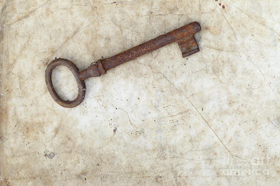 Rusty key on old parchment #3 Photograph by Michal Boubin