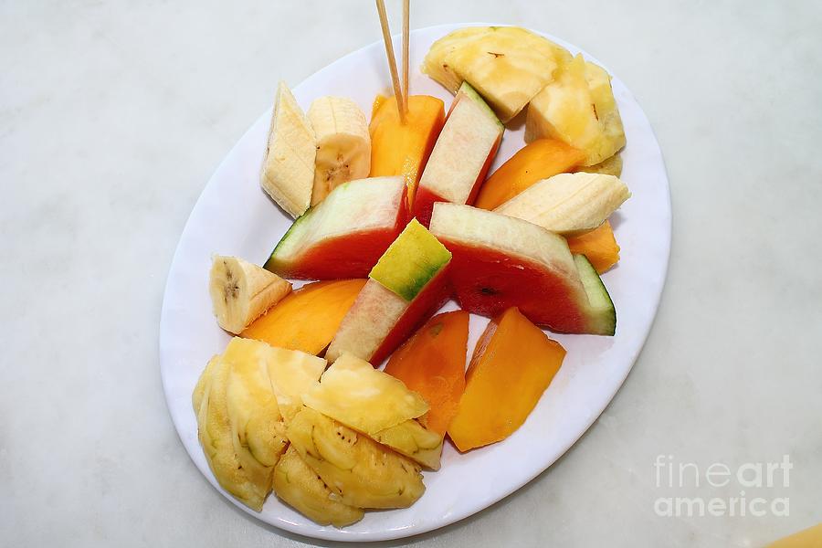 White Plate With Sliced Fruit Watermelon, Mango, Banana, Pineapple And Fresh Juice. Photograph